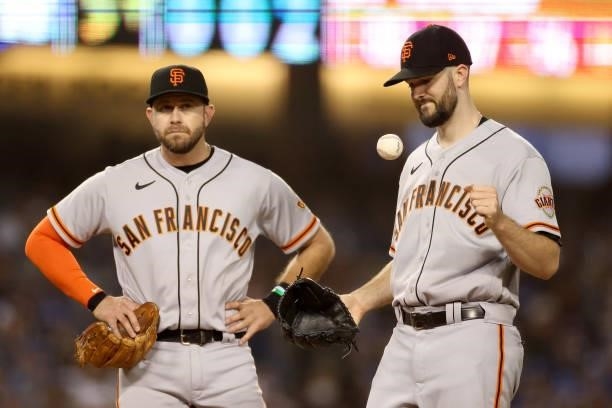 Alex Wood of the San Francisco Giants reacts as he is relieved while Evan Longoria looks on during the fifth inning in game 3 of the National League...