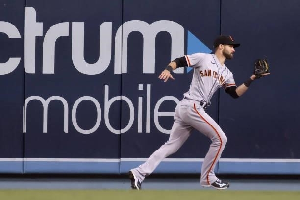 Steven Duggar of the San Francisco Giants makes a running catch for an out against Chris Taylor of the Los Angeles Dodgers during the sixth inning in...