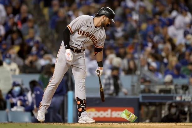 Kris Bryant of the San Francisco Giants pushes away a peanut bag during the seventh inning in game 3 of the National League Division Series against...