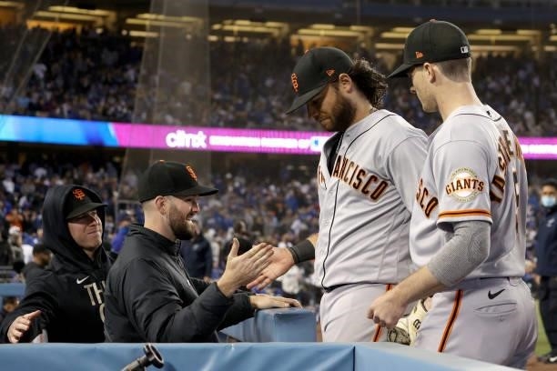 Brandon Crawford receives a hand shake Alex Wood of the San Francisco Giants after making a defensive play for an out against Mookie Betts of the Los...