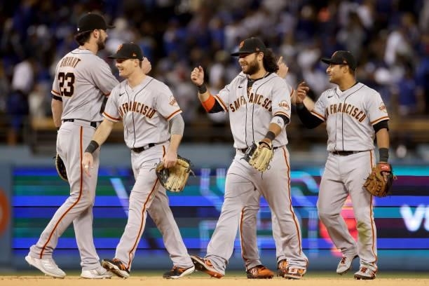 Kris Bryant, Mike Yastrzemski, Brandon Crawford and Donovan Solano of the San Francisco Giants celebrate beating the Los Angeles Dodgers 1-0 in game...