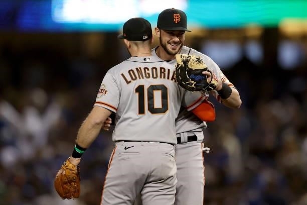 Evan Longoria and Kris Bryant of the San Francisco Giants celebrate after beating the Los Angeles Dodgers 1-0 in game 3 of the National League...