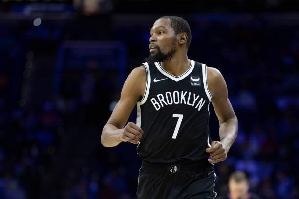 Kevin Durant of the Brooklyn Nets looks on against the Philadelphia 76ers at the Wells Fargo Center on October 11, 2021 in Philadelphia,...