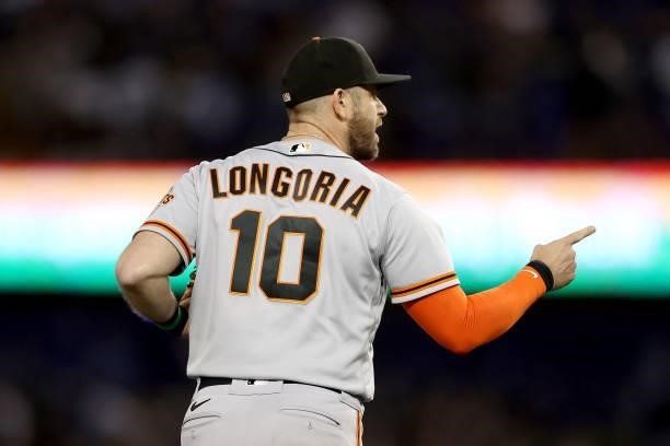 Evan Longoria of the San Francisco Giants celebrates after beating the Los Angeles Dodgers 1-0 in game 3 of the National League Division Series at...