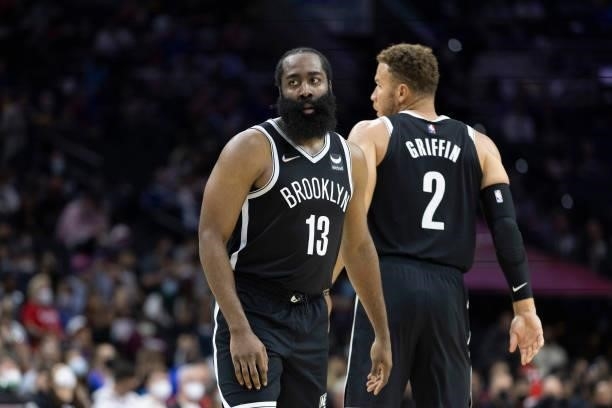 James Harden and Blake Griffin of the Brooklyn Nets look on against the Philadelphia 76ers at the Wells Fargo Center on October 11, 2021 in...