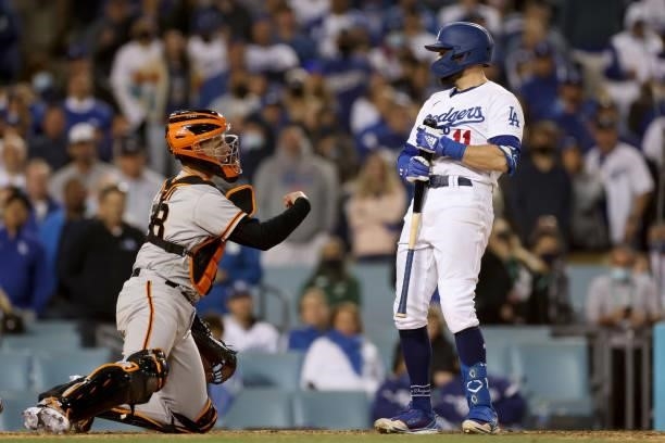 Pollock of the Los Angeles Dodgers reacts after striking out in front of Buster Posey of the San Francisco Giants during the ninth inning in game 3...