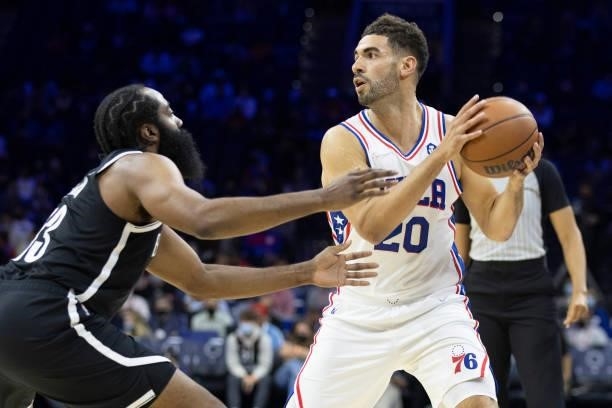 Georges Niang of the Philadelphia 76ers controls the ball against James Harden of the Brooklyn Nets at the Wells Fargo Center on October 11, 2021 in...