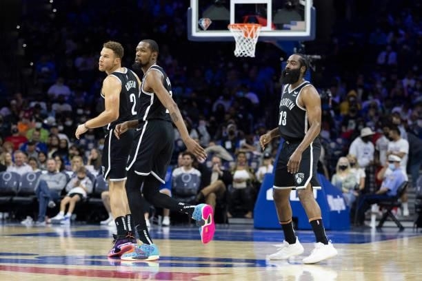 Blake Griffin, Kevin Durant, and James Harden of the Brooklyn Nets look on against the Philadelphia 76ers at the Wells Fargo Center on October 11,...