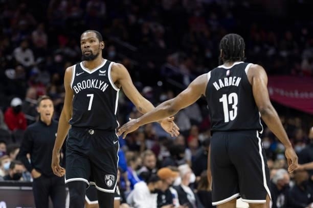 Kevin Durant and James Harden of the Brooklyn Nets react against the Philadelphia 76ers at the Wells Fargo Center on October 11, 2021 in...