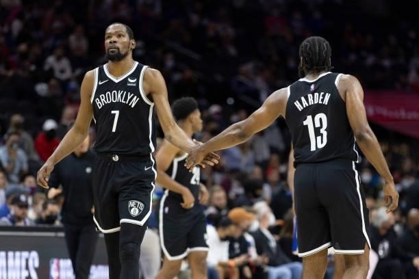 Kevin Durant and James Harden of the Brooklyn Nets react against the Philadelphia 76ers at the Wells Fargo Center on October 11, 2021 in...