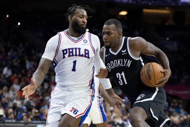 Paul Millsap of the Brooklyn Nets drives to the basket against Andre Drummond of the Philadelphia 76ers at the Wells Fargo Center on October 11, 2021...
