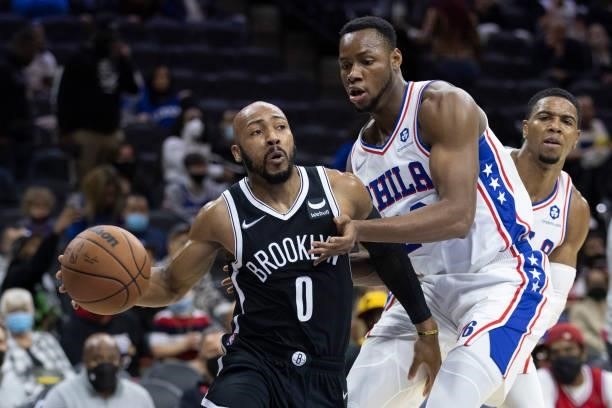 Jevon Carter of the Brooklyn Nets drives to the basket against Charles Bassey of the Philadelphia 76ers at the Wells Fargo Center on October 11, 2021...