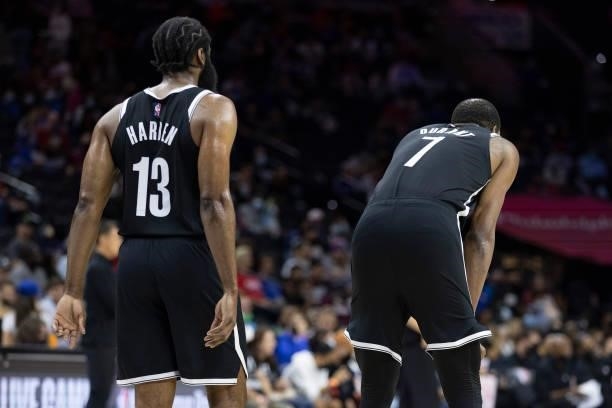 James Harden and Kevin Durant of the Brooklyn Nets look on against the Philadelphia 76ers at the Wells Fargo Center on October 11, 2021 in...