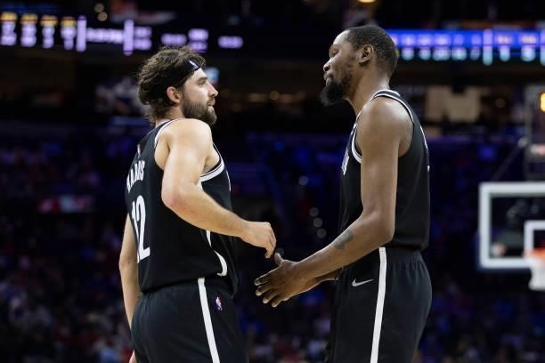 Joe Harris of the Brooklyn Nets talks to Kevin Durant against the Philadelphia 76ers at the Wells Fargo Center on October 11, 2021 in Philadelphia,...