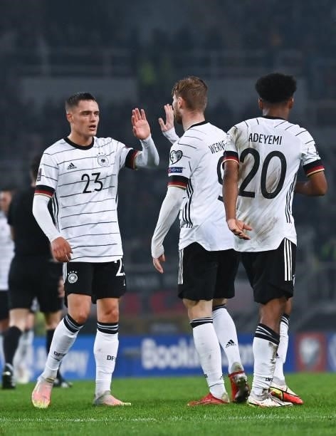 Florian Wirtz of Germany celebrates with Timo Werner and Karim Adeyemi of Germany during the 2022 FIFA World Cup Qualifier match between North...