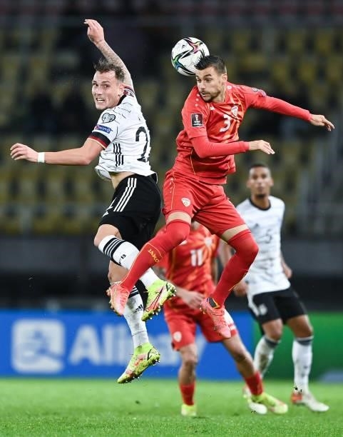 David Raum of Germany challenges for the ball with Stefan Ashkovski of North Macedonia during the 2022 FIFA World Cup Qualifier match between North...