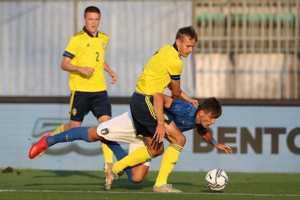 Jesper Tolinsson of Sweden clashes with Lorenzo Lucca of Italy during the 2022 UEFA European Under-21 Championship Qualifier match between Italy and...