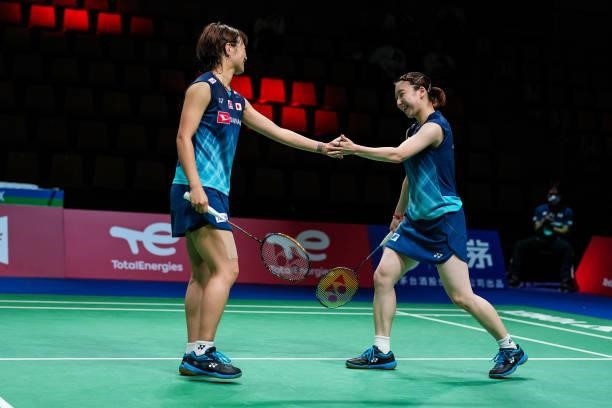 Yuki Fukushima and Arisa Higashino of Japan react in the Women's Double match against Nita Violina Marwah and Putri Syaikah of Indonesia during day...