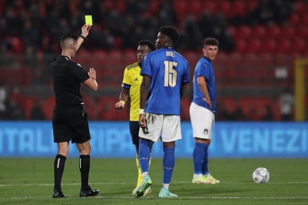 Caleb Okoli of Italy looks on as Anthony Elanga of Sweden is shown a yellow card by the referee Antonio Emanuel Carvalho Nobre of Portugal after...