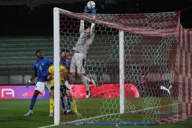 Caleb Okoli and Raoul Bellanova of Italy look on as team mate and goalkeeper Stefano Turati tips the ball over the crossbar under pressure from an...