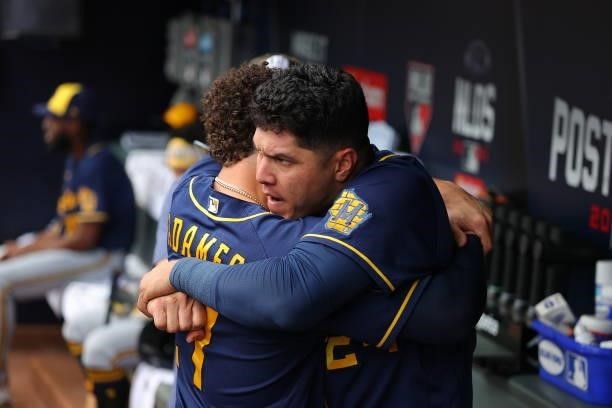 Willy Adames of the Milwaukee Brewers and Avisail Garcia embrace prior to the start of the game against the Atlanta Braves at Truist Park on October...