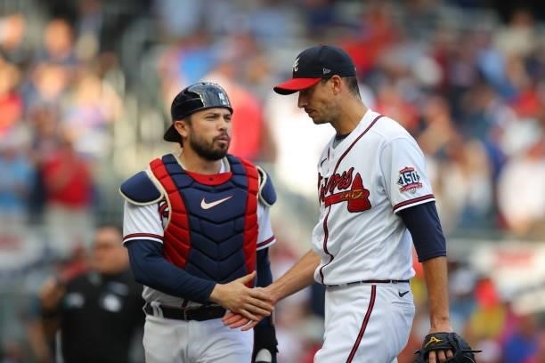 Travis d'Arnaud of the Atlanta Braves and Charlie Morton walk to the dugout during the first inning in game four of the National League Division...