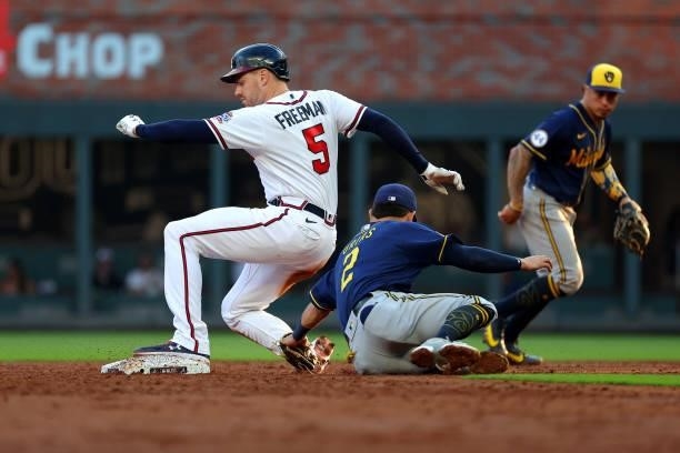 Freddie Freeman of the Atlanta Braves is safe at second ahead of Luis Urias of the Milwaukee Brewers during the third inning in game four of the...