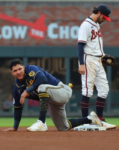 Avisail Garcia of the Milwaukee Brewers advances to second on a wild throw to first ahead of Dansby Swanson of the Atlanta Braves during the fourth...