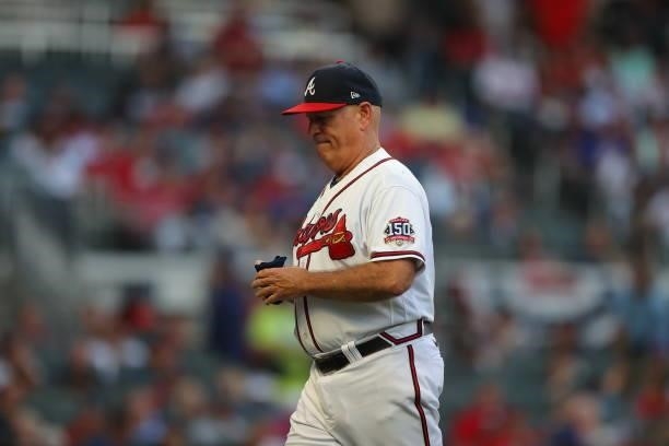 Manager Brian Snitker of the Atlanta Braves walks back to the dugout during the fourth inning against the Milwaukee Brewers in game four of the...