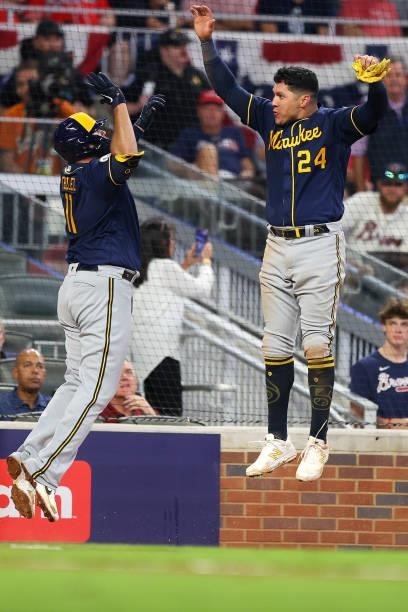 Avisail Garcia of the Milwaukee Brewers and Rowdy Tellez celebrate during the fifth inning in game four of the National League Division Series...