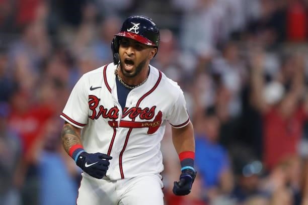 Eddie Rosario of the Atlanta Braves racts to a two RBI single during the fourth inning against the Milwaukee Brewers in game four of the National...