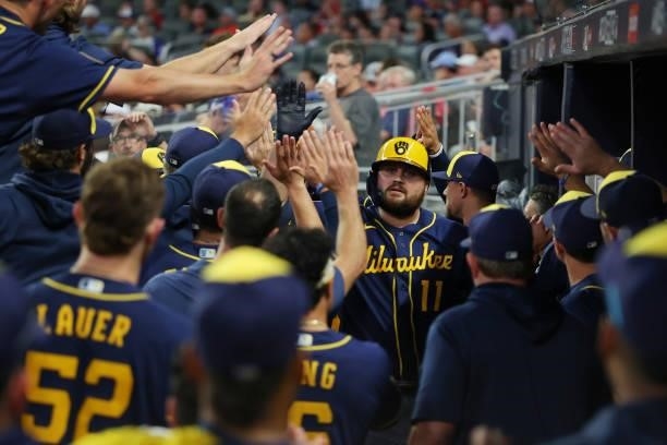 Rowdy Tellez of the Milwaukee Brewers celebrates in the dugout after a two run home run during the fifth inning against the Atlanta Braves in game...