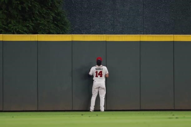 Adam Duvall of the Atlanta Braves watches a home run by Rowdy Tellez of the Milwaukee Brewers during the fifth inning in game four of the National...