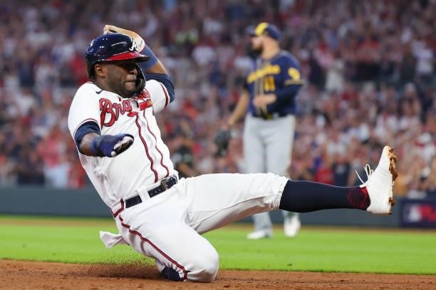 Guillermo Heredia of the Atlanta Braves slides into third during the fourth inning in game four of the National League Division Series against the...