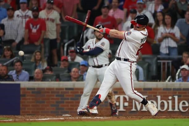 Joc Pederson of the Atlanta Braves hits an RBI single during the fifth inning against the Milwaukee Brewers in game four of the National League...