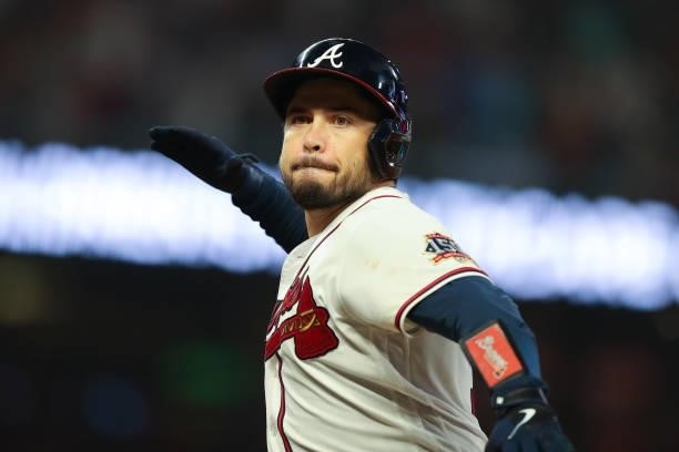 Travis d'Arnaud of the Atlanta Braves reacts to a run scored in the 5th against the Milwaukee Brewers in game four of the National League Division...
