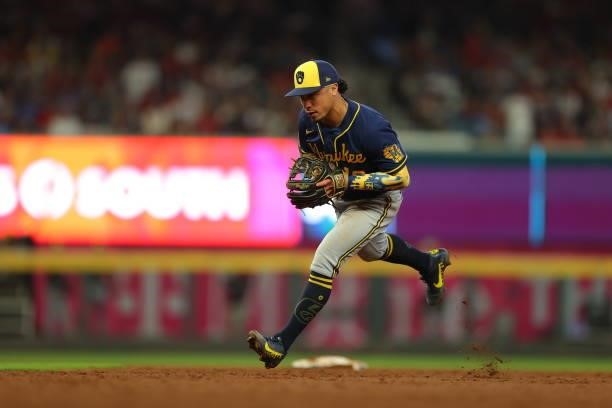 Kolten Wong of the Milwaukee Brewers fields a grounder and throws to first during the sixth inning against the Atlanta Braves in game four of the...