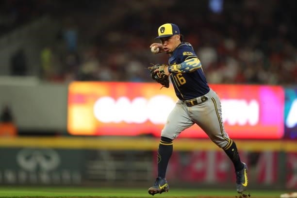 Kolten Wong of the Milwaukee Brewers fields a grounder and throws to first during the sixth inning against the Atlanta Braves in game four of the...