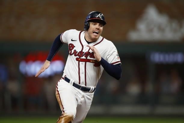 Freddie Freeman of the Atlanta Braves runs to third during the sixth inning against the Milwaukee Brewers in game four of the National League...