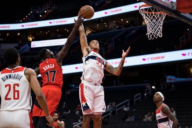 Kyle Kuzma of the Washington Wizards and Isaac Bonga of the Toronto Raptors battle for the ball during the first half at Capital One Arena on October...