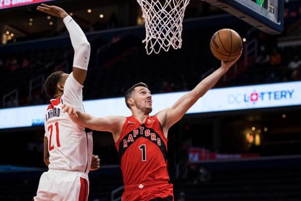Goran Dragic of the Toronto Raptors goes to the basket against Daniel Gafford of the Washington Wizards during the first half at Capital One Arena on...