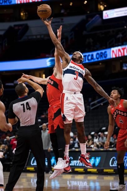 Bradley Beal of the Washington Wizards wins a jump ball against Goran Dragic of the Toronto Raptors during the first half at Capital One Arena on...