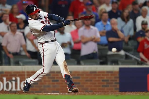 Travis d'Arnaud of the Atlanta Braves drives in a run during the fifth inning against the Milwaukee Brewers in game four of the National League...