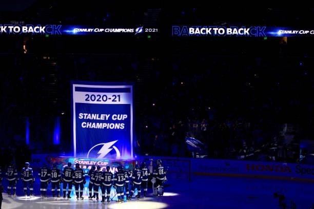 The Tampa Bay Lightning watch as a banner celebrating their 2020-21 Stanley Cup Championship before the first period of a game against the Pittsburgh...