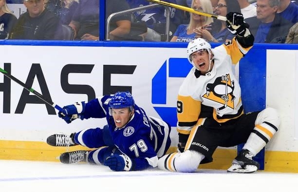 Ross Colton of the Tampa Bay Lightning and Evan Rodrigues of the Pittsburgh Penguins collide during the first period of a game at Amalie Arena on...