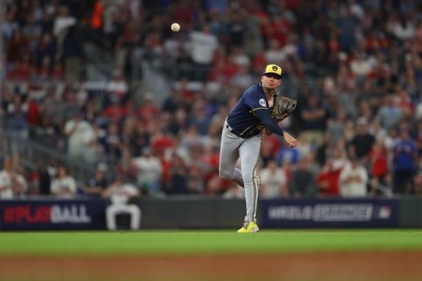 Willy Adames of the Milwaukee Brewers fields a ground ball to get out of the 7th inning against the Atlanta Braves in game four of the National...