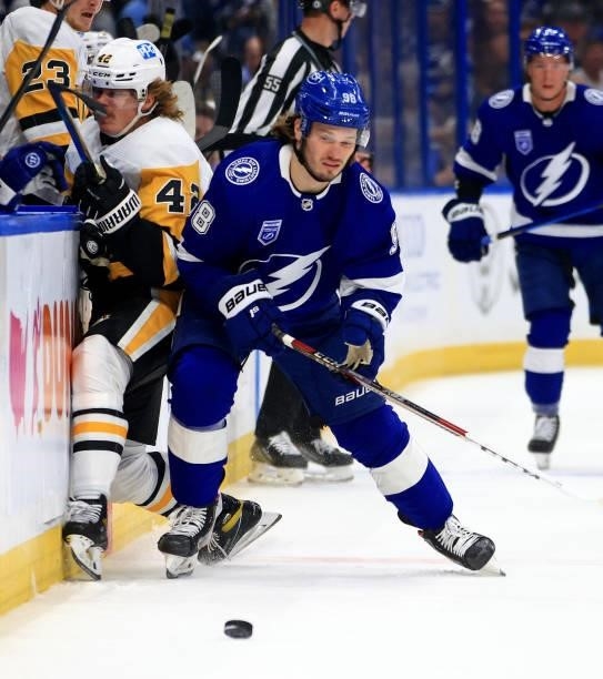 Kasperi Kapanen of the Pittsburgh Penguins and Mikhail Sergachev of the Tampa Bay Lightning collide during the first period of a game at Amalie Arena...
