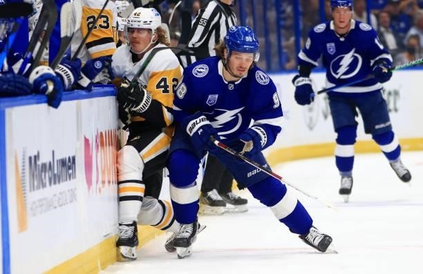 Kasperi Kapanen of the Pittsburgh Penguins and Mikhail Sergachev of the Tampa Bay Lightning collide during the first period of a game at Amalie Arena...