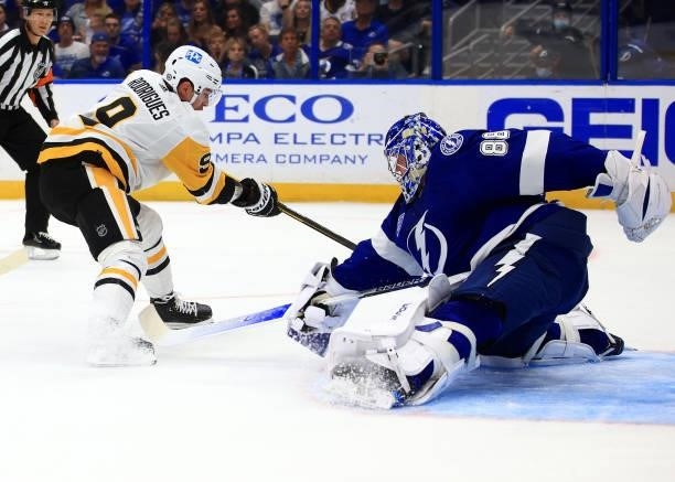 Andrei Vasilevskiy of the Tampa Bay Lightning stops a shot from Evan Rodrigues of the Pittsburgh Penguins during the first period of a game at Amalie...
