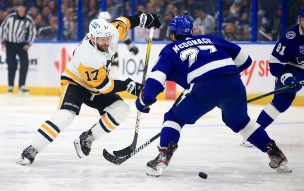 Bryan Rust of the Pittsburgh Penguins is defended by Ryan McDonagh of the Tampa Bay Lightning during the first period of a game at Amalie Arena on...